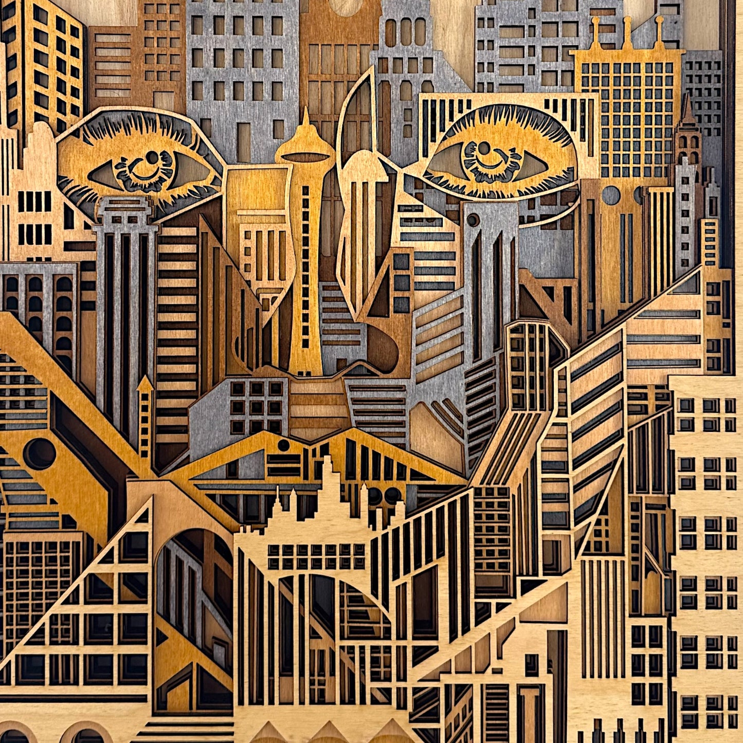Close-up of wooden laser-cut city design revealing subtle human features embedded in the high-rise buildings