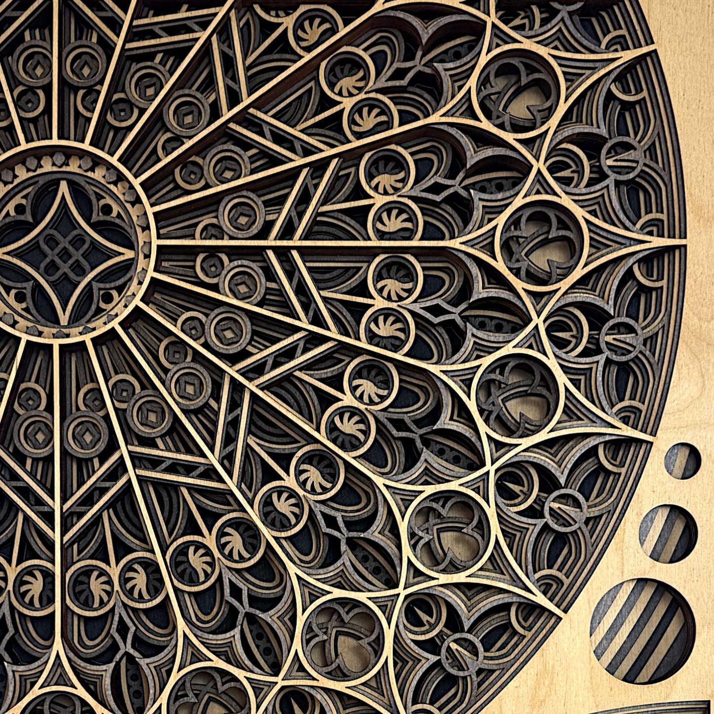 Close-up of the upper rose window, showing the intricate radial lines, gothic arches, and multi-layered cutouts in fine detail.