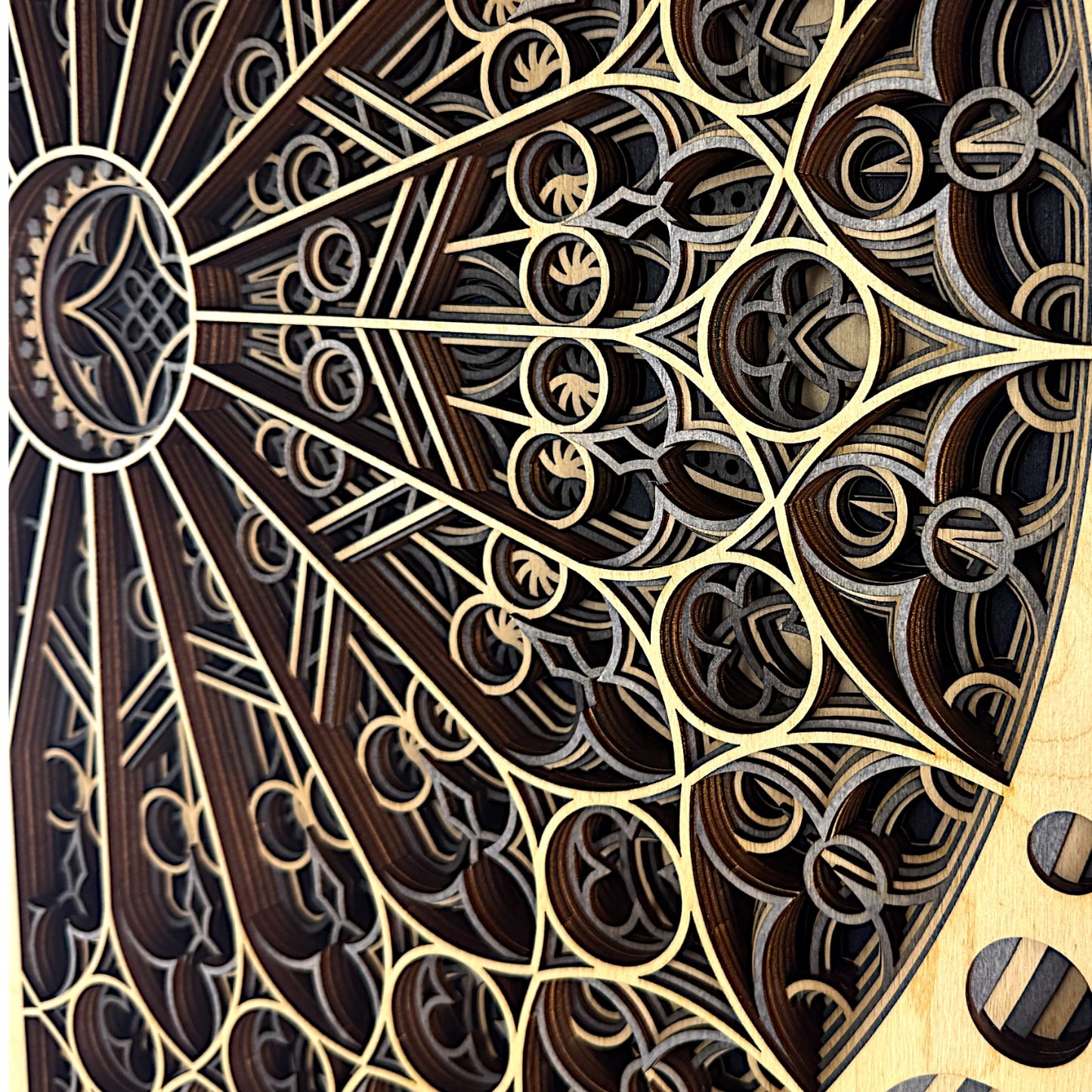 Detail shot of layered segments, emphasizing the handcrafted laser-cut lines, flowing symmetry, and natural wood textures.