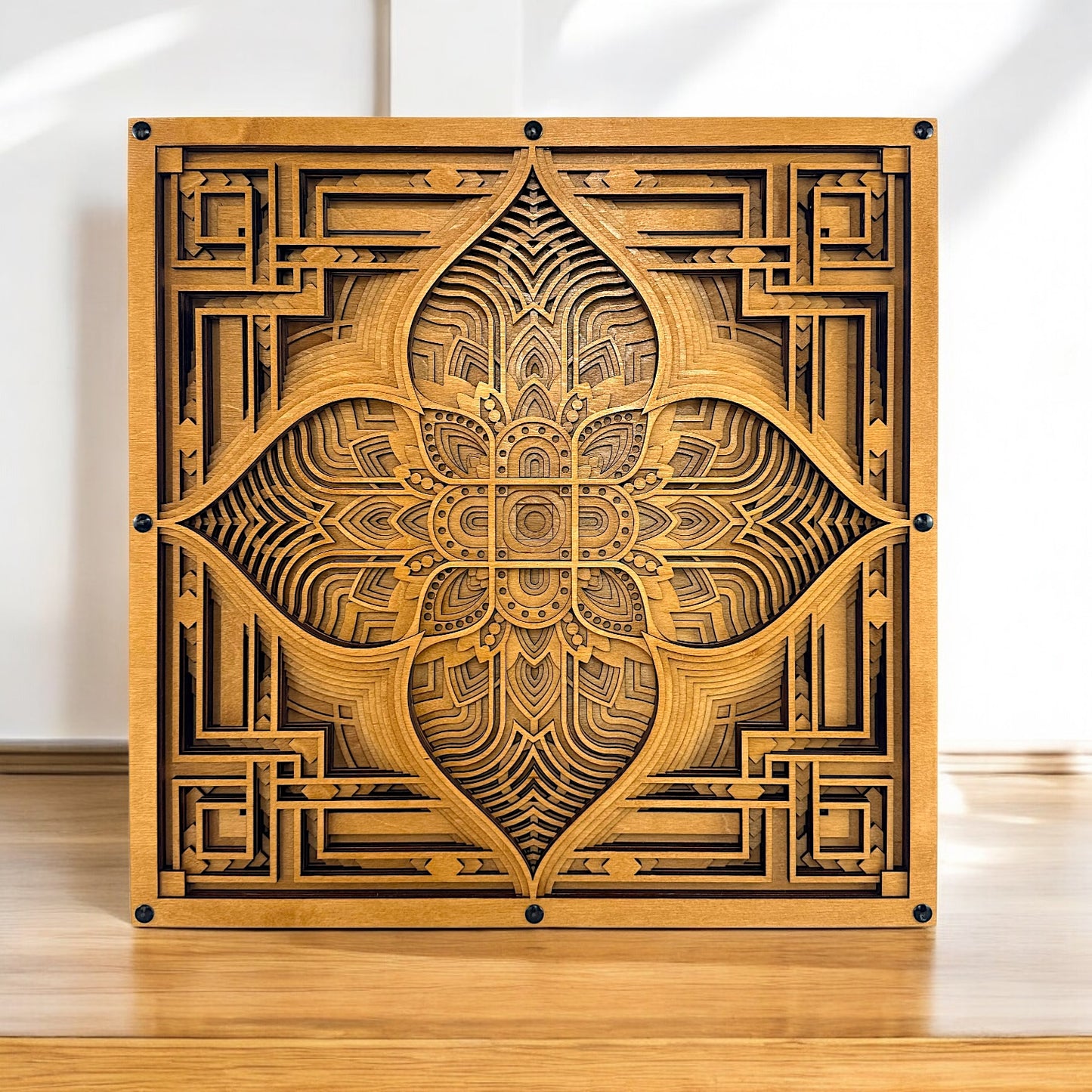 Driftpetal displayed upright on a smooth wooden surface with soft daylight, showcasing its warm tones and central floral motif.