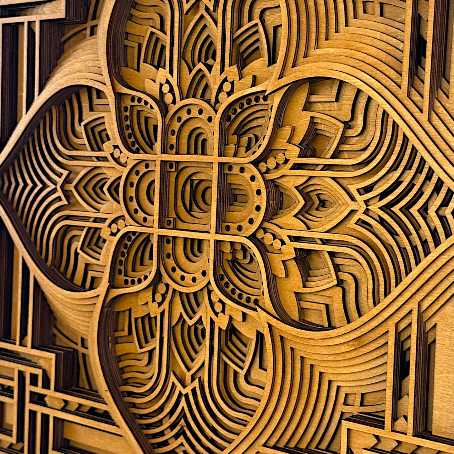 Extreme close-up of the layered wood design in Driftpetal, showing the crisp contours, fine curves, and multi-depth construction.
