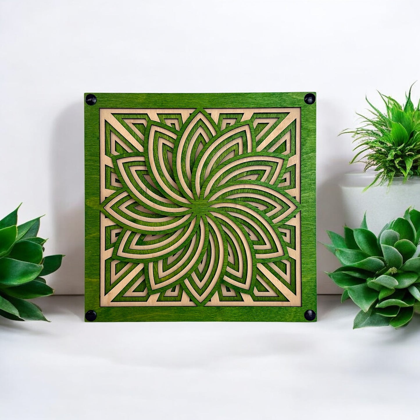 Floraspiral sculpture displayed with succulent plants, emphasizing its natural floral influence and tabletop scale.