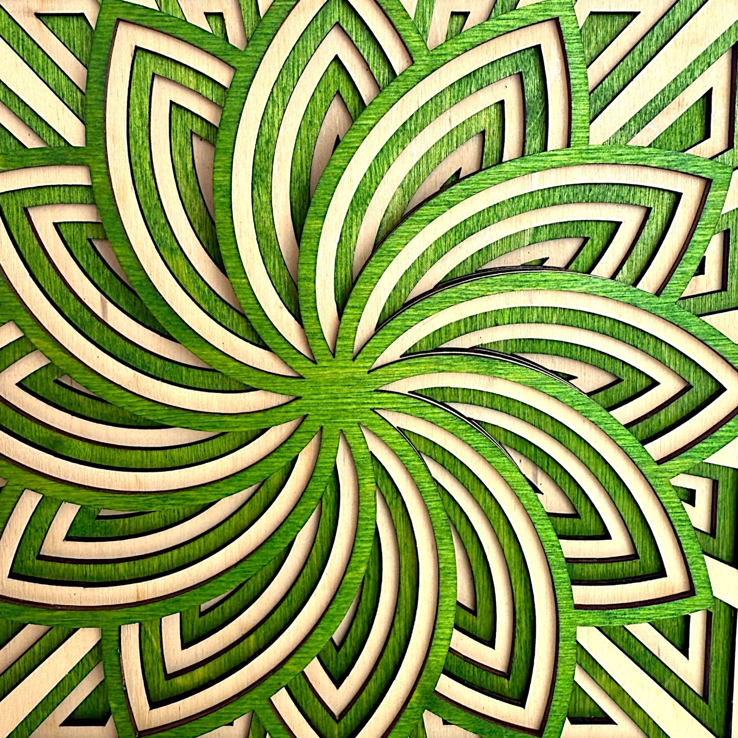 Macro detail of Floraspiral’s floral spiral pattern, showcasing intricate layering and smooth natural wood grain.