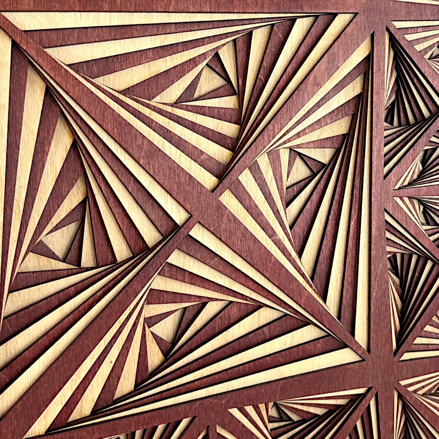 Close-up image of the central section, emphasizing the crisp lines and layered depth of the laser-cut triangular design.