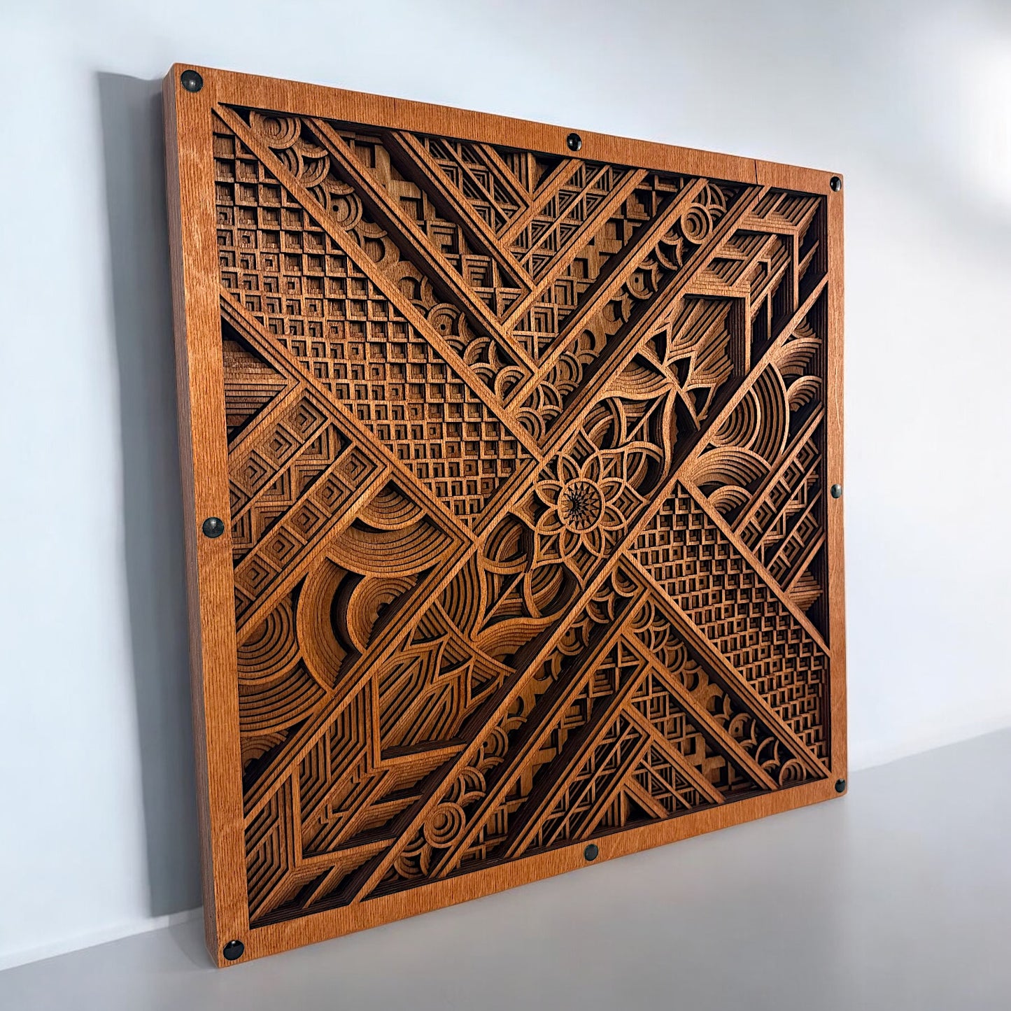 Left-angled view of the artwork mounted on the wall, highlighting the depth and layered construction of the mandala design.