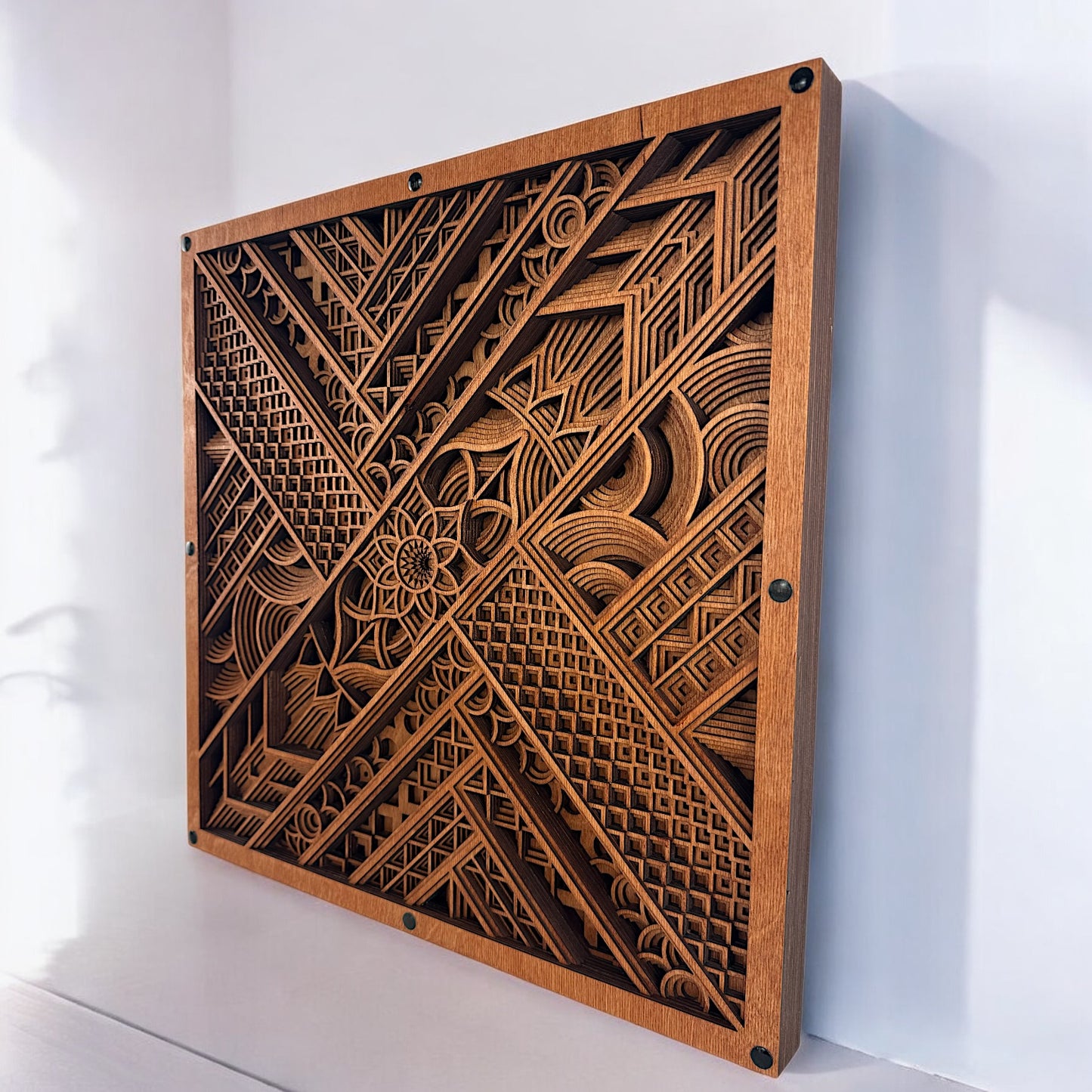 Right-angled perspective showing the dimensionality of the laser-cut layers and the rich wood stain used in the piece.