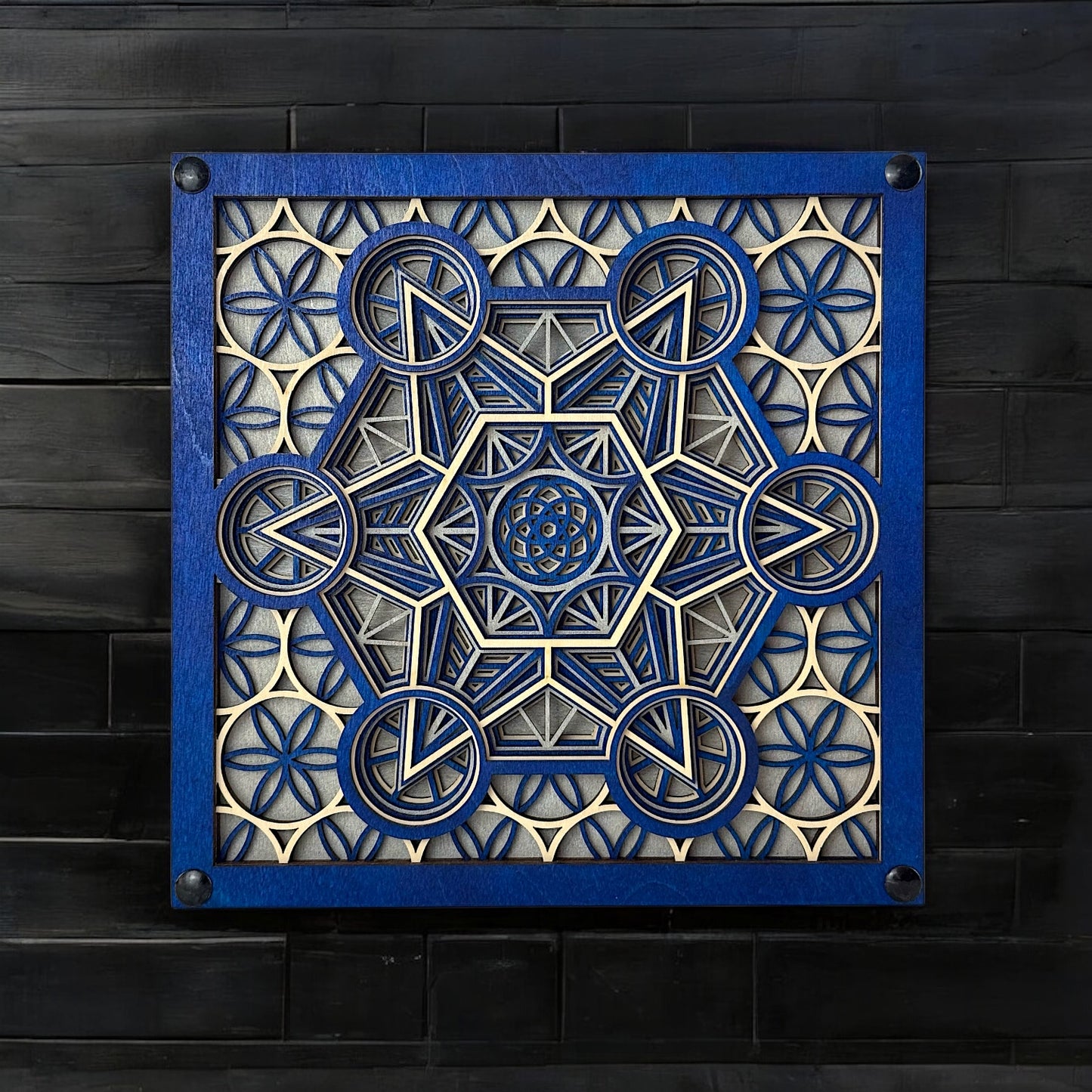 "Metatron Ascend" displayed on a black wood wall, emphasizing the artwork's bold contrast and geometric symmetry.