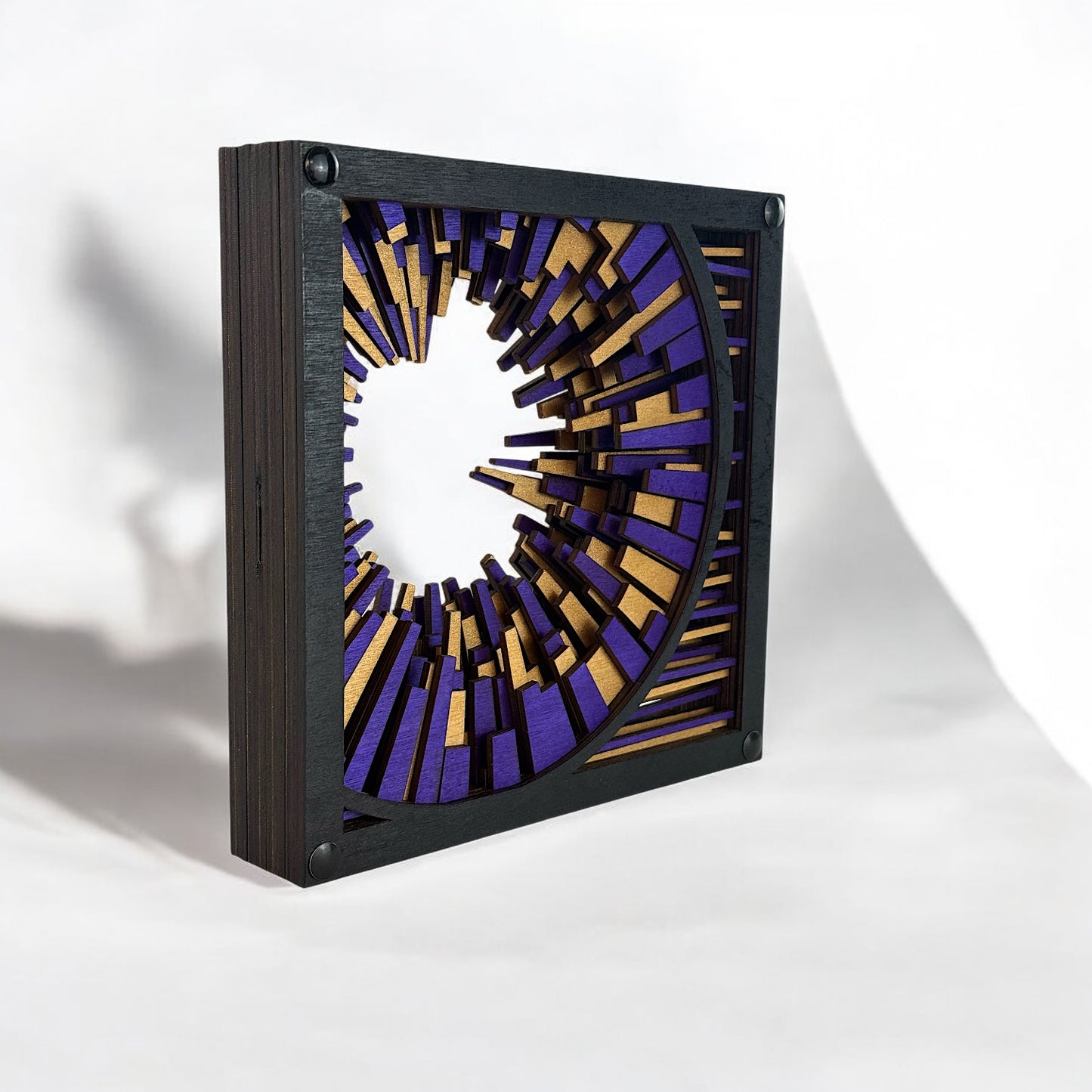 Right-side perspective of the layered abstract sculpture, emphasizing the radial motion and shadowed depth.