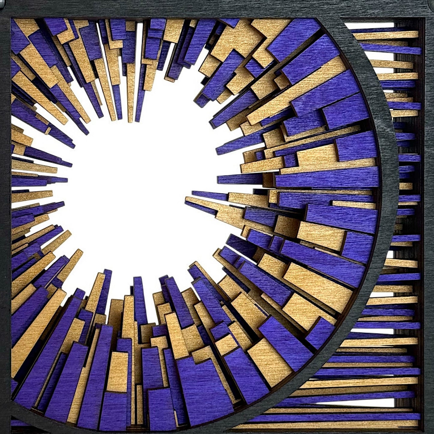 Close-up of geometric burst pattern in purple and gold, showing the precise craftsmanship and radial composition.