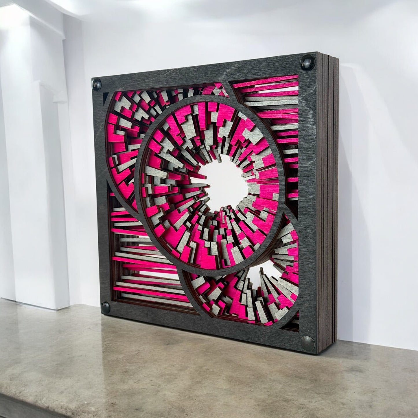 Freestanding artwork displayed in a modern interior with polished concrete, showcasing its bold color and crisp cuts.