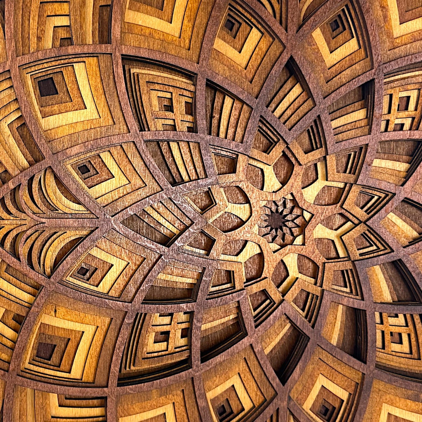 Close-up of the center of the Petal Maze piece, revealing intricate laser-cut geometry and starburst-like detail.