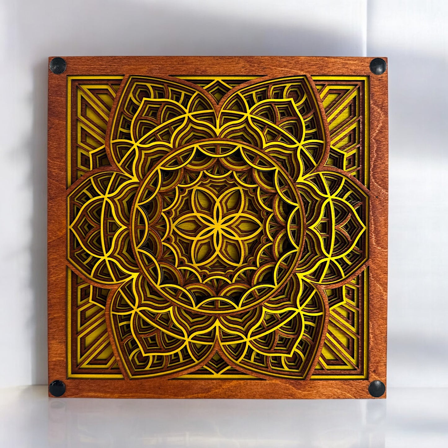 Front view of Quantum Blossom artwork – A 12-layer geometric mandala wall piece featuring vibrant yellow and earthy brown tones in an intricate flower-of-life pattern.