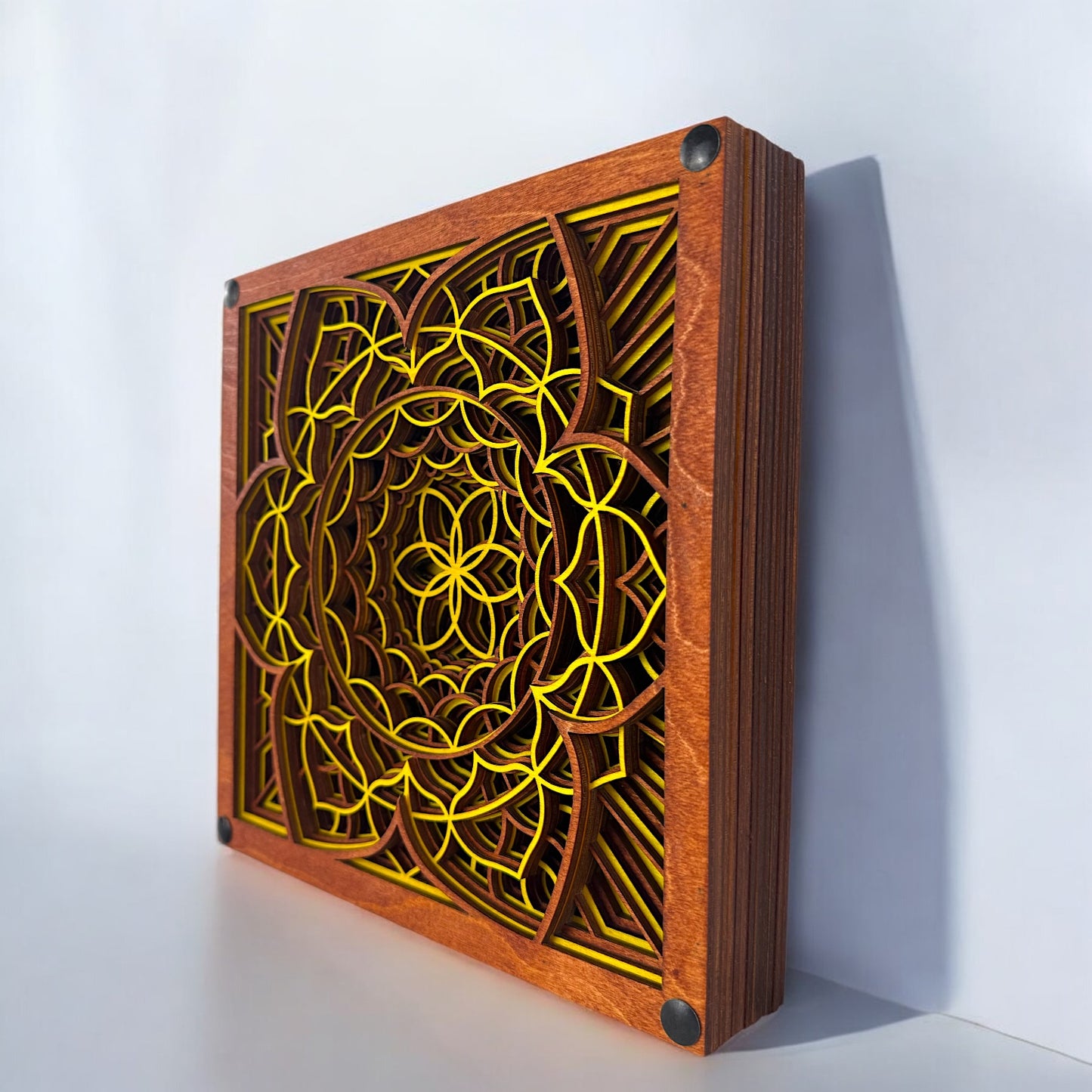 Side profile of Quantum Blossom – A detailed close-up of the multi-dimensional layered structure in a square wood frame stained with a rich amber hue.