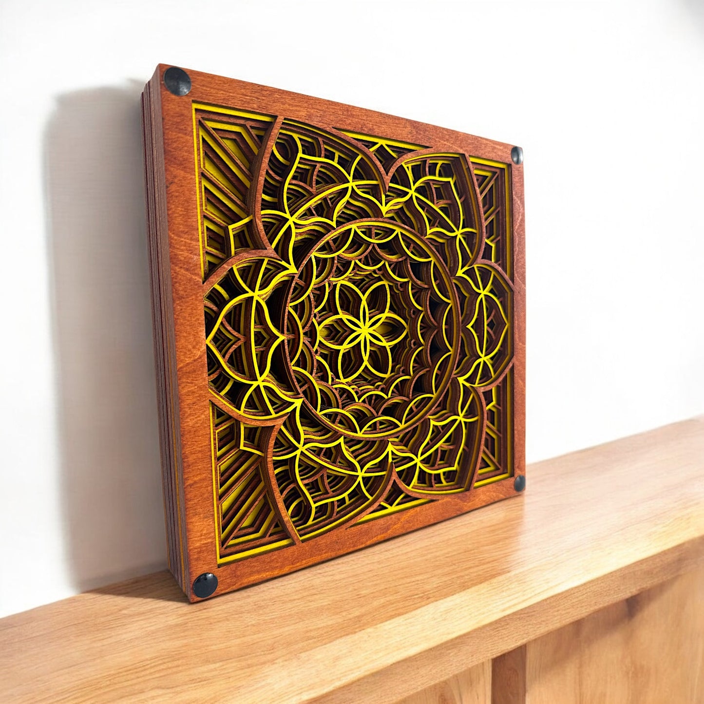 Displayed on wooden shelf – Vibrant laser-cut mandala decor shown on a shelf in natural lighting, highlighting depth and symmetry.