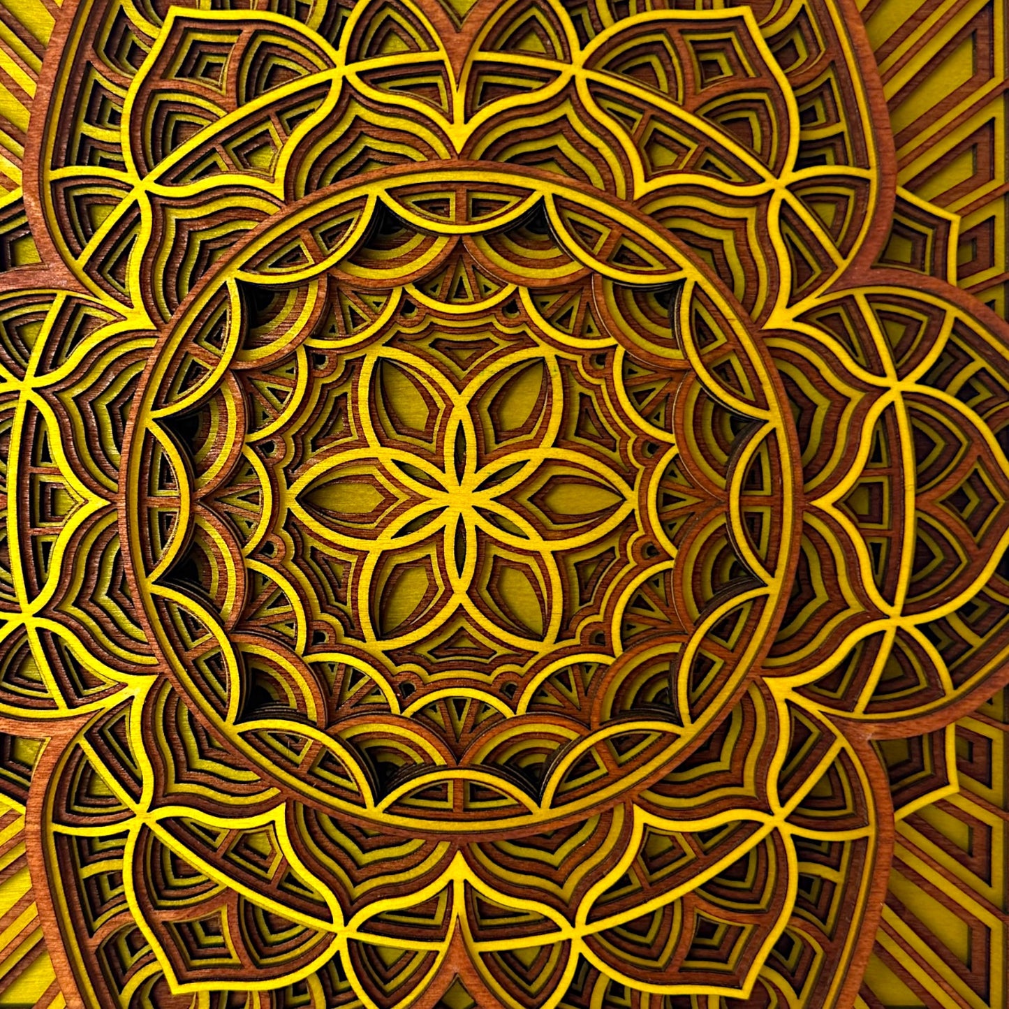 Close-up center pattern detail – Detailed macro shot of the flower-like center of the Quantum Blossom artwork, revealing the precision-cut yellow and wood layers.