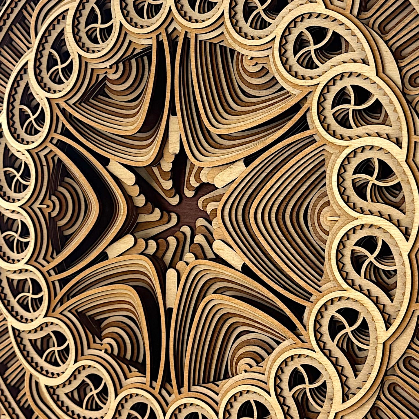 Close-up image focusing on the core star-shaped center of the Solar Bloom piece, emphasizing fine craftsmanship and layered depth.