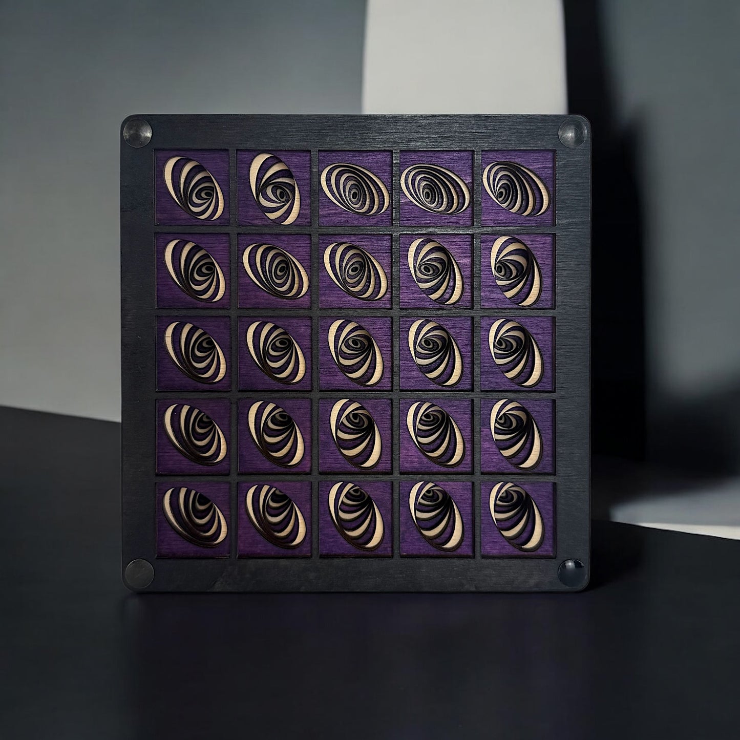 Vortex Array wooden wall art photographed under dramatic lighting, emphasizing contrast in the layered spirals and rich purple tones.