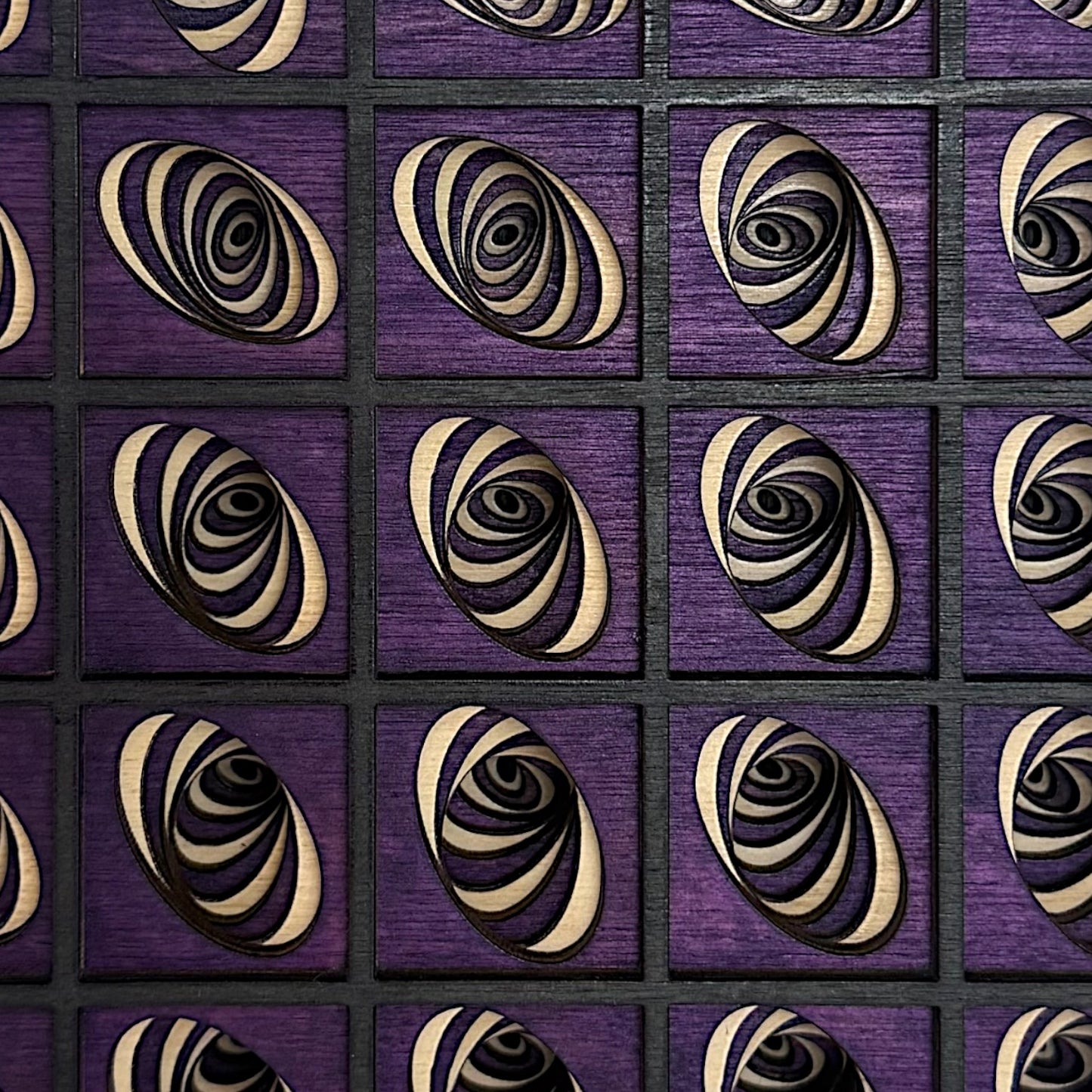 Close-up of Vortex Array artwork revealing fine detail in each vortex's curves, with natural wood and black-stained layers over purple.