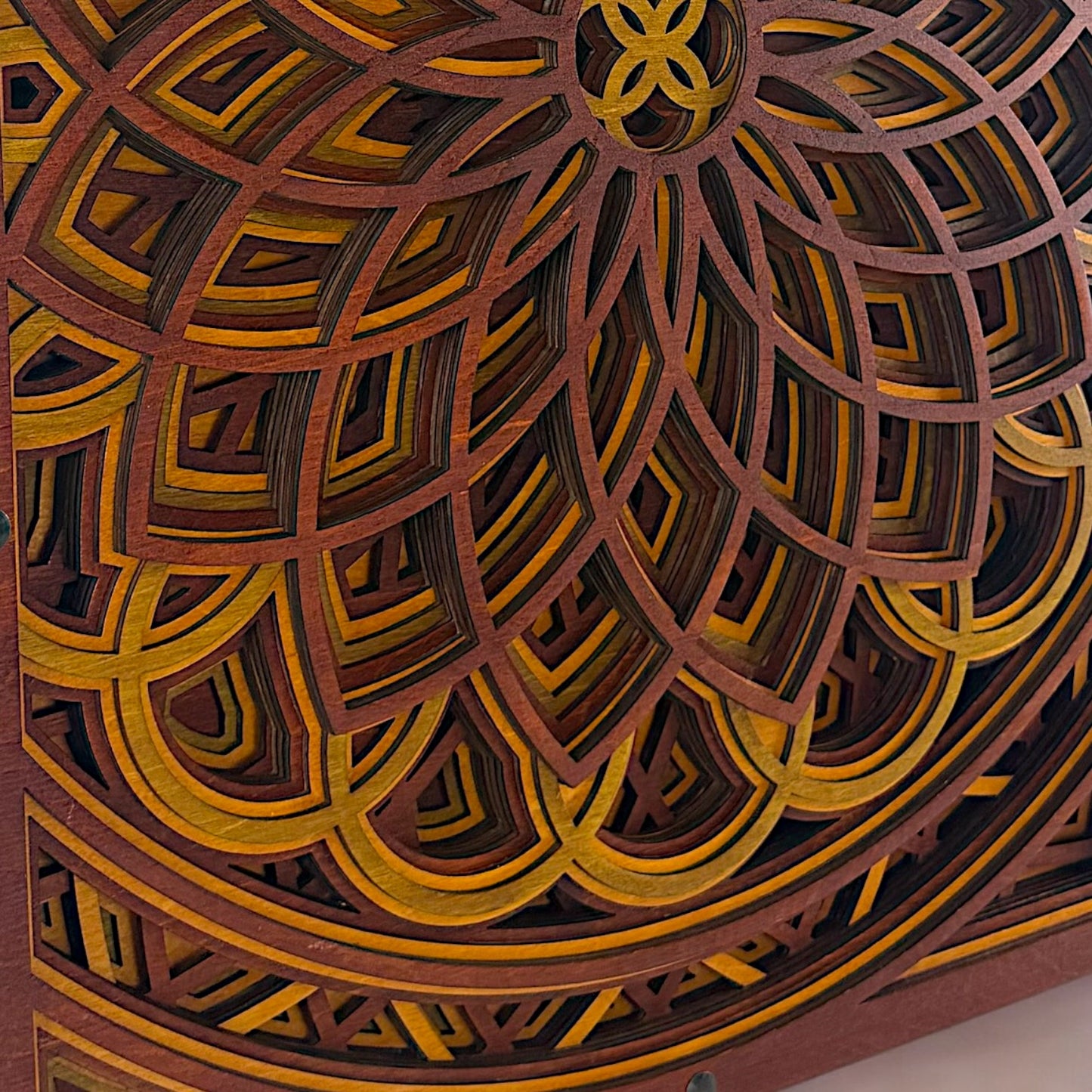 Extreme close-up of the bottom half of the piece, highlighting the layered petal shapes and contrasting warm wood tones.