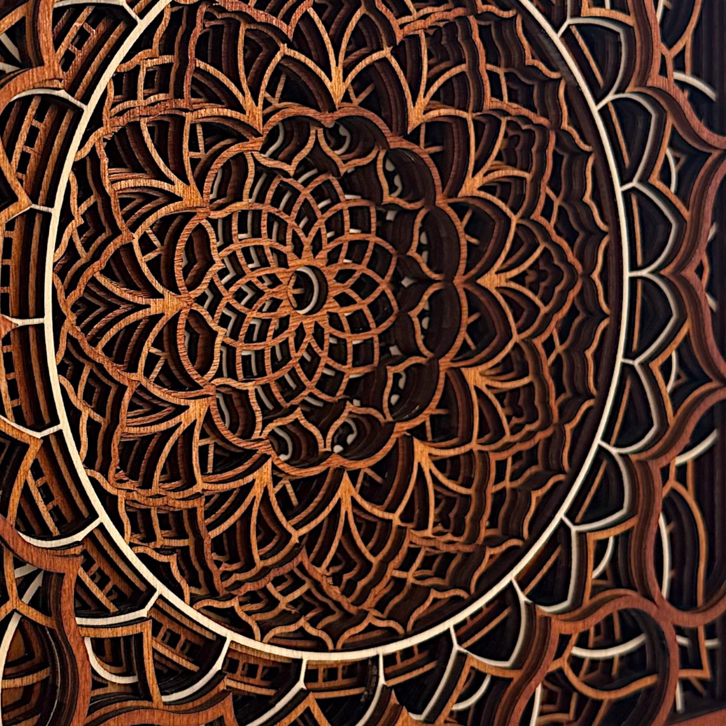 Macro side detail of Vortex Reliquary's layered structure, showing the interplay of light and shadow through intricate cuts.