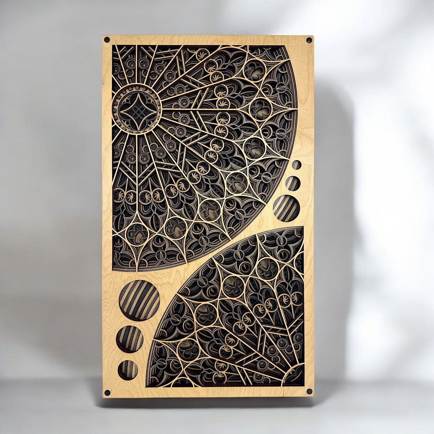 Front view of Cathedral Flow wall art featuring intricate 10-layer laser-cut woodwork inspired by Gothic rose windows, with light natural wood framing.