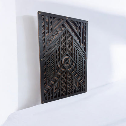 Laser-cut wood wall art displayed upright on a white surface, showing the layered design’s depth and complex geometric detailing in dark wood tones.