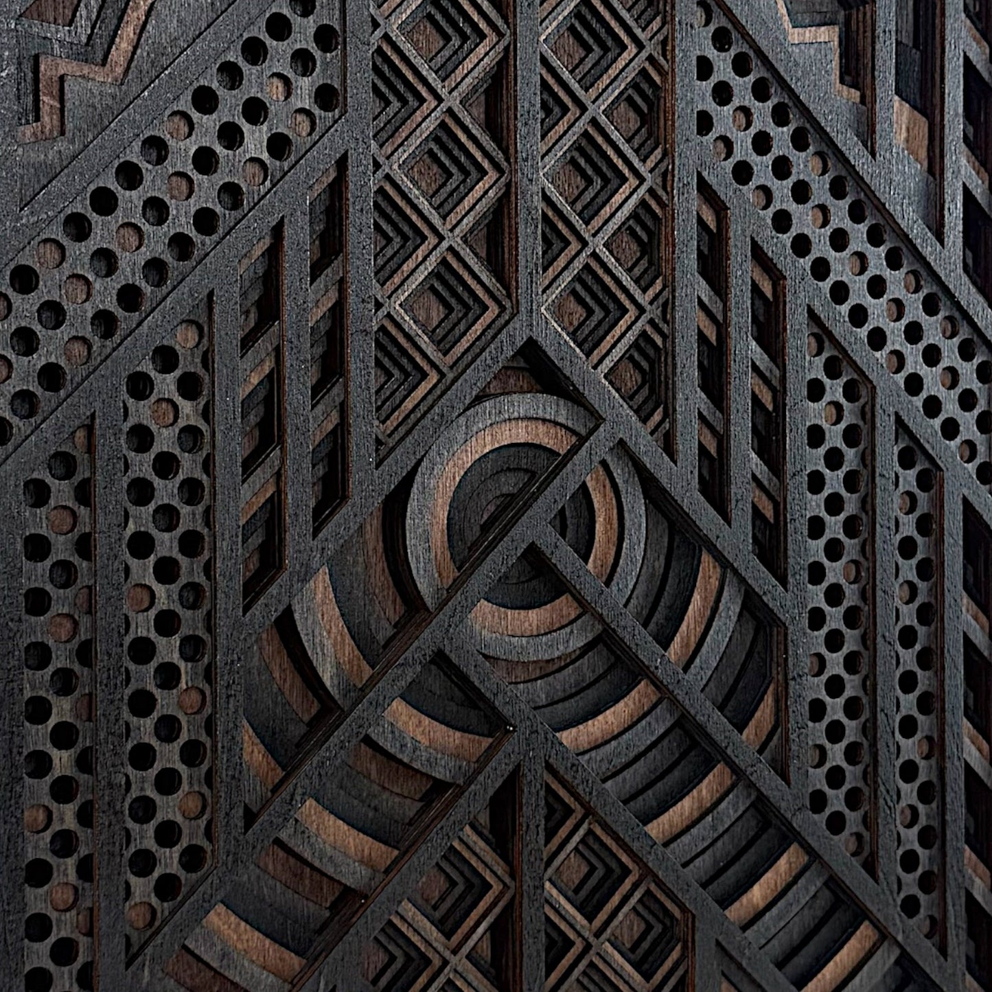 Close-up of the central section of a layered wood wall art piece, emphasizing the crisp laser cuts, concentric arcs, and fine diamond gridwork.