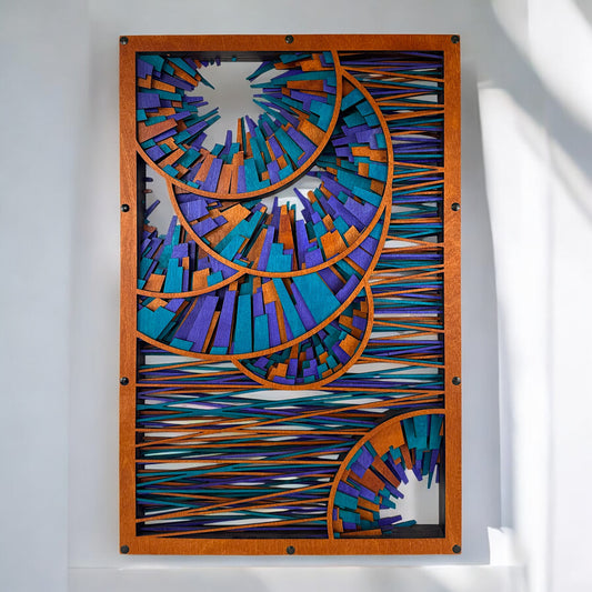Front view of a multi-layered laser-cut wood wall art piece featuring interlocking spiral arcs filled with dynamic rectangular segments in teal, violet, and copper tones.