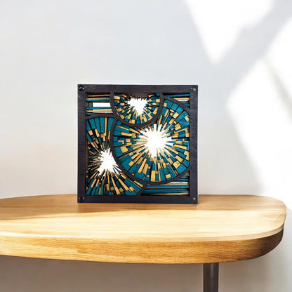 Metrorhythm V3 sculpture on a wooden shelf, catching sunlight to reveal its intricate cuts and glowing color palette.