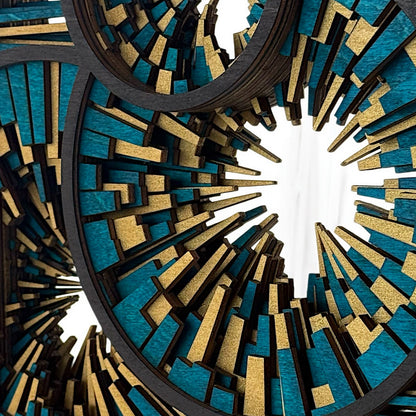 Close-up of layered wood segments in teal and gold, showing fine detail and texture within the radial pattern.
