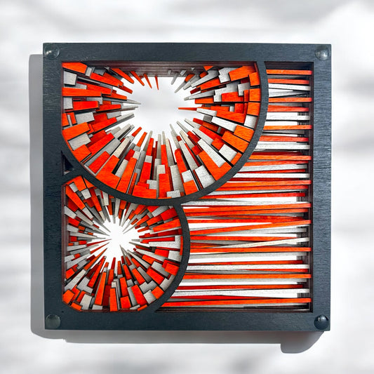 Front view of Metrorhythm V4 freestanding wood sculpture featuring orange, silver, and black geometric layers with circular bursts.