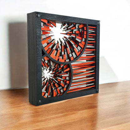 Close-up of geometric laser-cut art on a darker wooden base, emphasizing depth and layered craftsmanship.