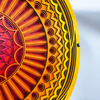 Close-up of the outer edge showing detailed carving and pattern transitions in bright yellow and orange wood layers.