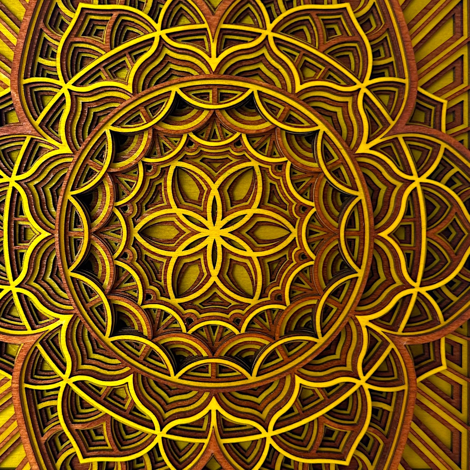 Close-up center pattern detail – Detailed macro shot of the flower-like center of the Quantum Blossom artwork, revealing the precision-cut yellow and wood layers.