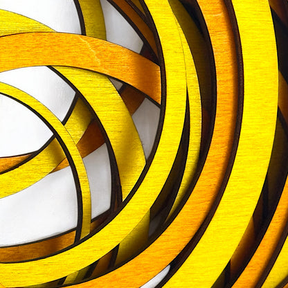 Extreme close-up of Radiant Drift art piece showing the fine texture of layered stained wood in bright yellow and deep orange tones.