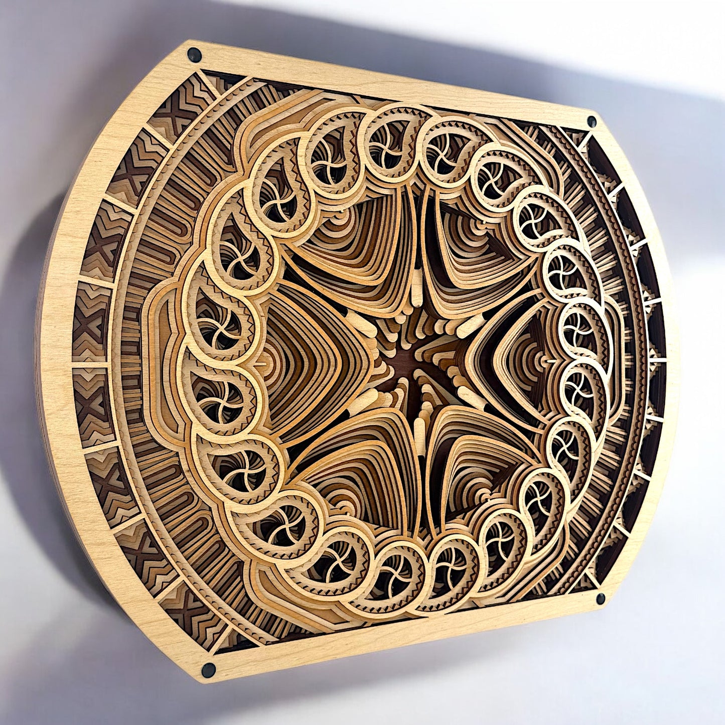 Top-down angled shot of the Solar Bloom wall decor highlighting its organic symmetry and complex concentric wood layers.