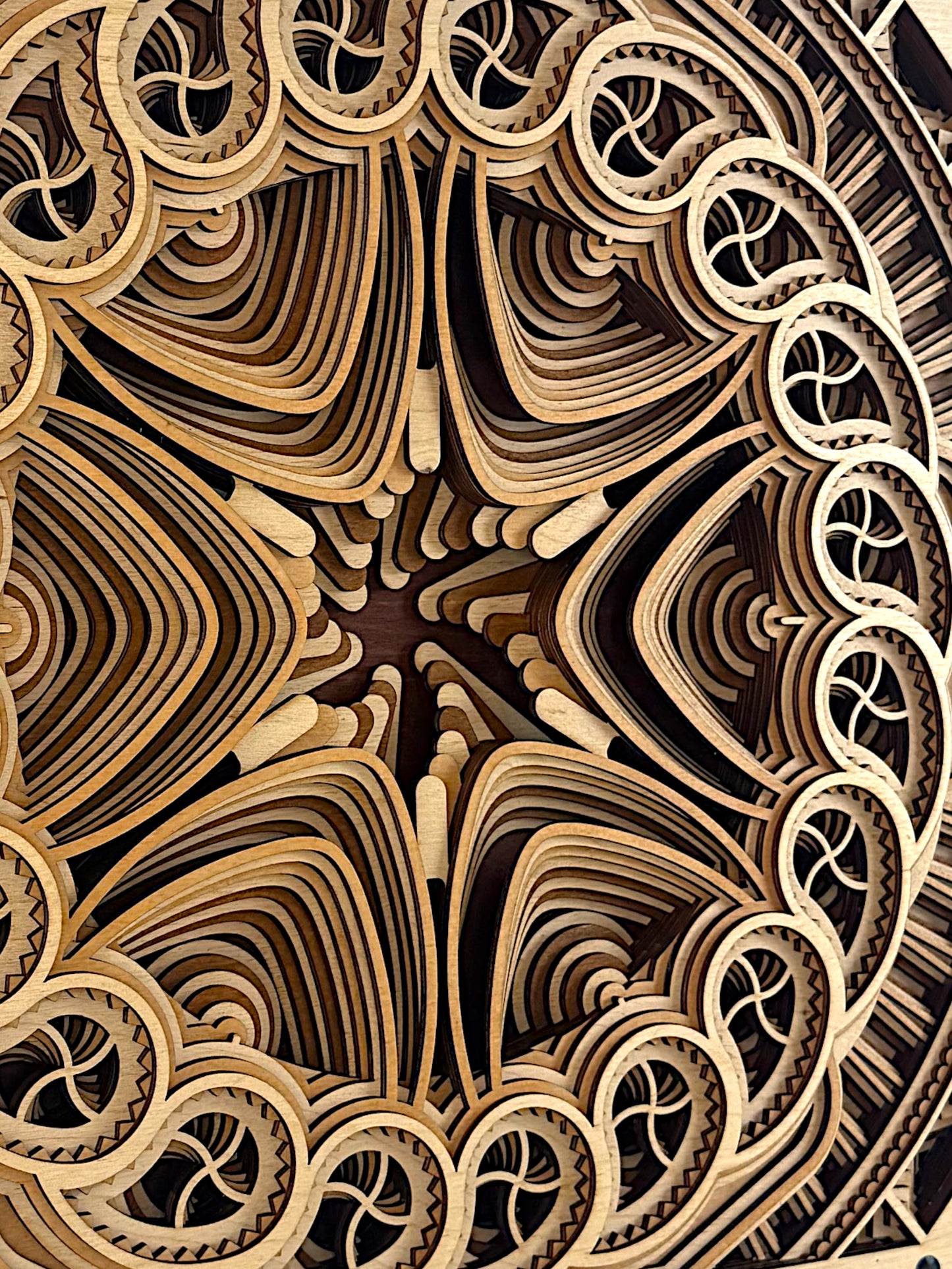 Extreme detail view of the layered mandala edges in Solar Bloom, revealing the flowing wood grain and sculptural contours of the design.