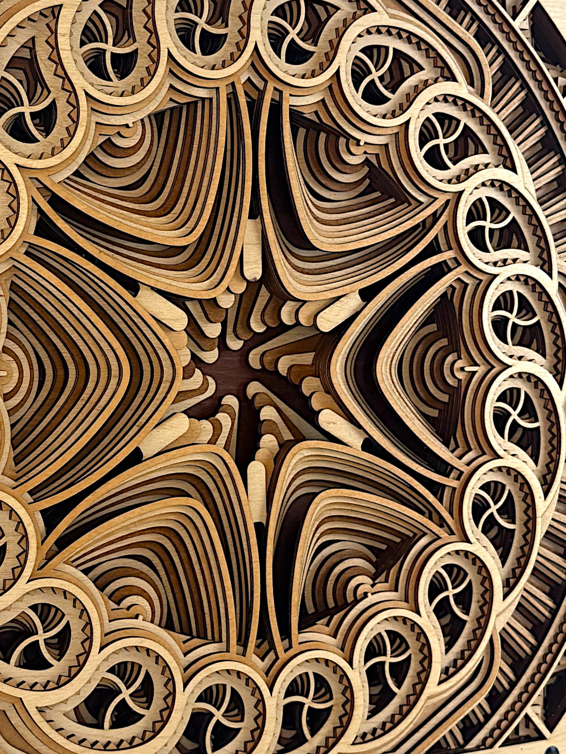 Extreme detail view of the layered mandala edges in Solar Bloom, revealing the flowing wood grain and sculptural contours of the design.