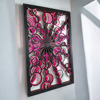 Right-angled hanging display, showing light and shadows interacting with the open layered rings and bold color accents.
