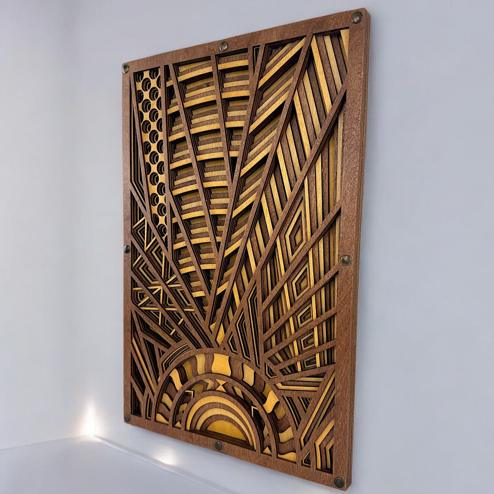 Angled close-up of layered Baltic Birch wood art showing laser-cut detail and dimensional depth