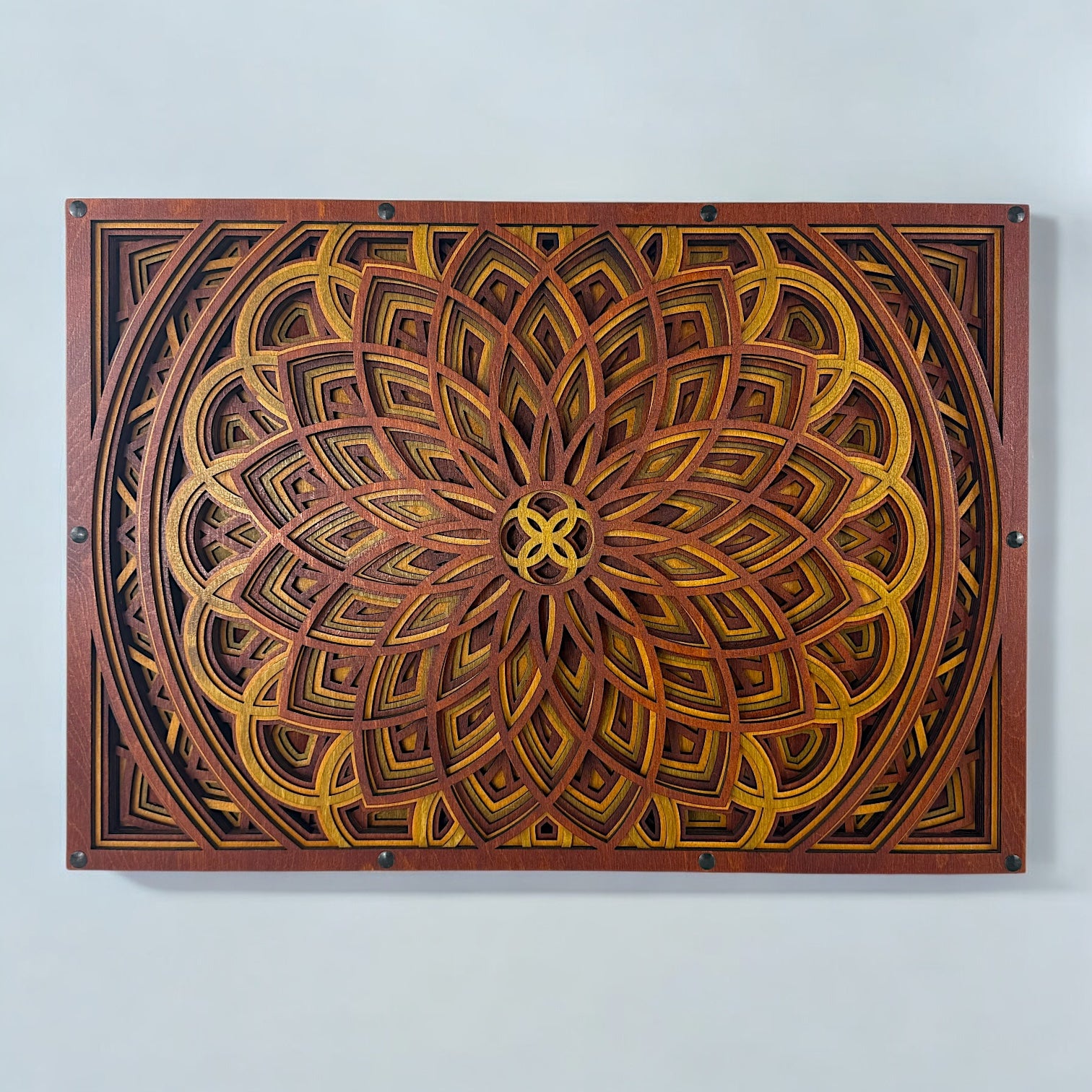 Front view of an 11-layer geometric mandala wood wall art piece in warm crimson, gold, and ember tones, mounted horizontally.