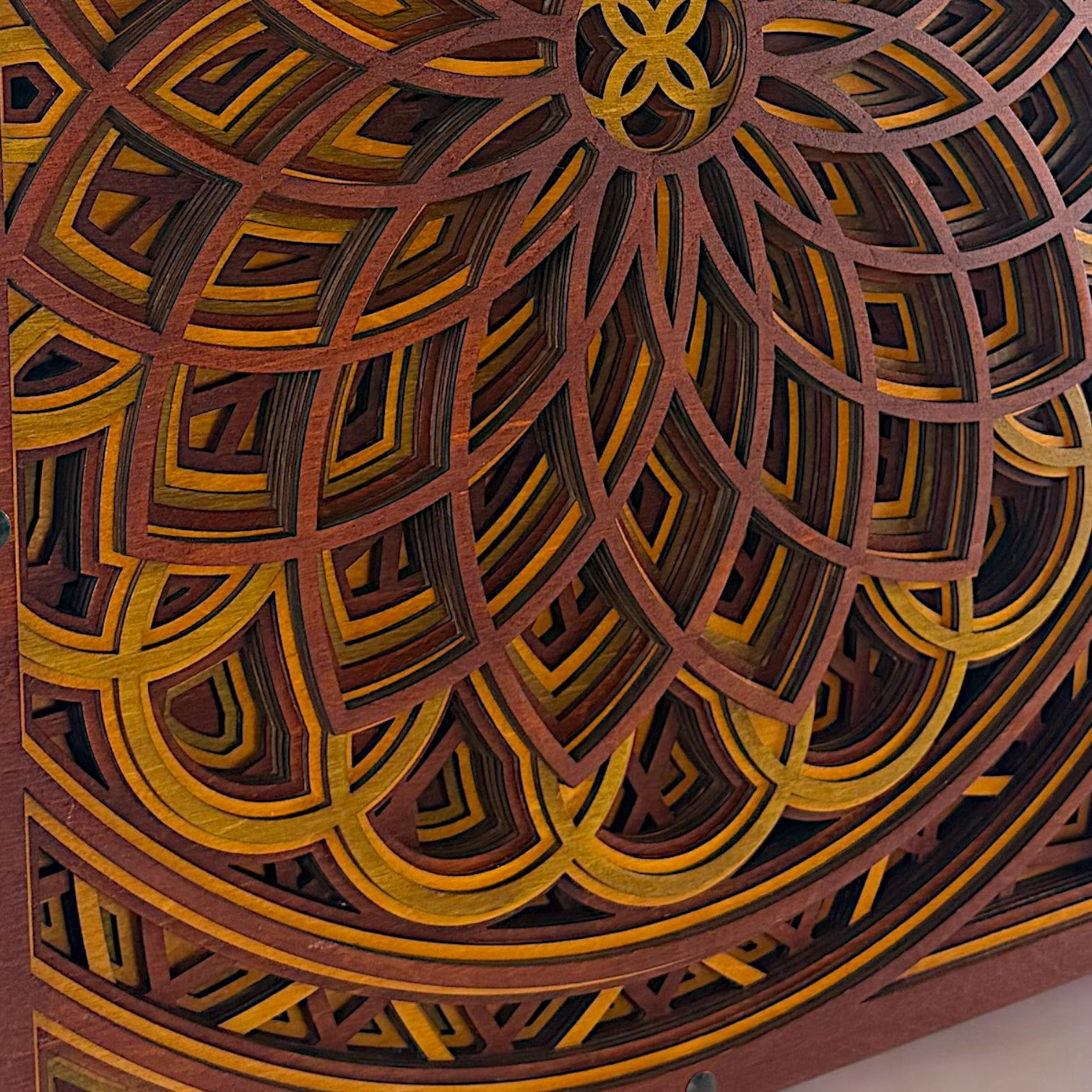 Extreme close-up of the bottom half of the piece, highlighting the layered petal shapes and contrasting warm wood tones.
